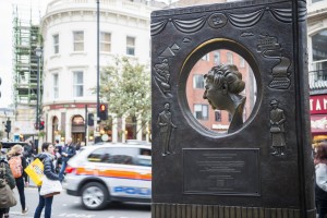 LONDON, UK - OCTOBER 26: Agatha Christie book shaped memorial with busy street in the background. The bronze memorial was unveiled on the 18 November 2012. October 26, 2014 in London.